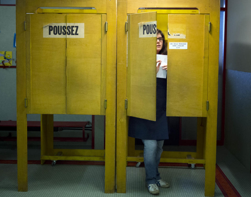 A Swiss voter leaves a polling box at a makeshift polling station after Swiss voters went to the polls to decide on a proposal to cap immigration to the Alpine republic, in the center of Geneva, Switzerland, Sunday, Feb. 9, 2014. The nationalist Swiss People’s Party demands a stop for immigration to Switzerland. (AP Photo/Anja Niedringhaus)