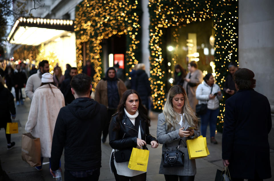 morale  People carry shopping bags as they walk past Christmas themed shop displays on Oxford Street in London, December 4, 2022. REUTERS/Henry Nicholls