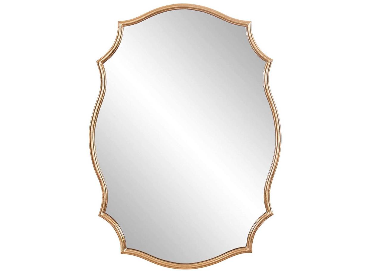 Add a touch of charm to your walls with this stunning gold mirror. 