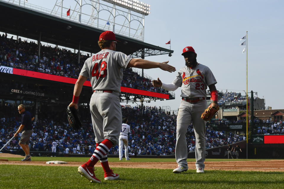 St. Louis Cardinals' Harrison Bader (48) slaps hands with Marcell Ozuna (23) after Ozuna caught a fly ball hit by Chicago Cubs' Kris Bryant to end the seventh inning of a baseball game Friday, Sept. 20, 2019, in Chicago. (AP Photo/Matt Marton)