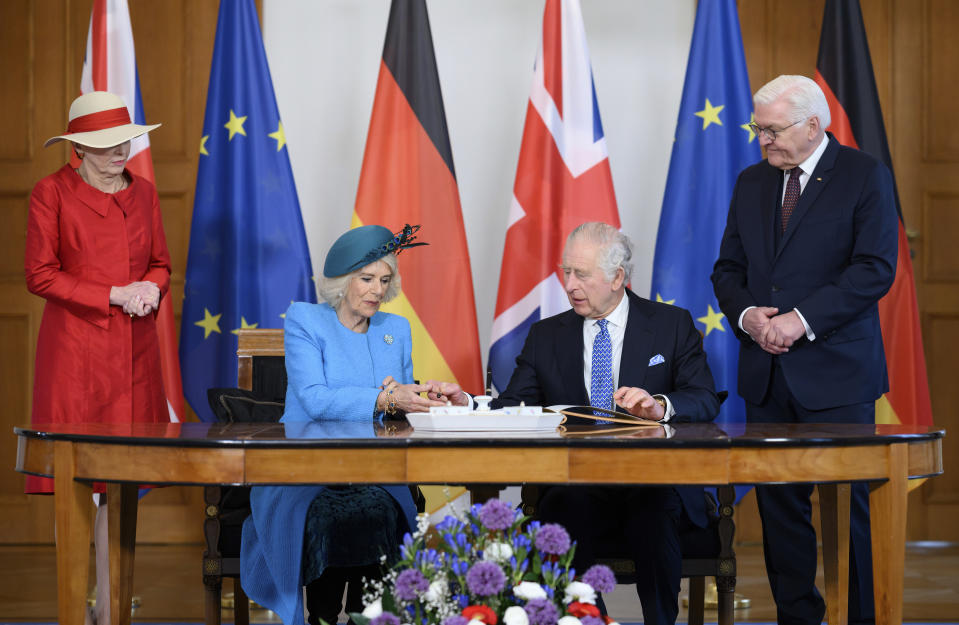 King Charles III (2nd from right) and his wife Camilla (2nd from left) sign the guest book in the presence of German President Frank-Walter Steinmeier and his wife Elke Buedenbender at Bellevue Palace in Berlin, Germany, Wednesday, March 29, 2023. Before his coronation in May 2023, the British King and his royal wife will visit Germany for three days .(Bernd von Jutrczenka/dpa via AP)