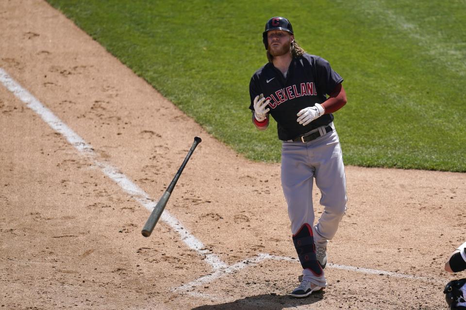 Cleveland Indians' Ben Gamel tosses his bat away after a walk during the third inning against the Chicago White Sox in a spring training baseball game Saturday, March 20, 2021, in Phoenix. (AP Photo/Ross D. Franklin)