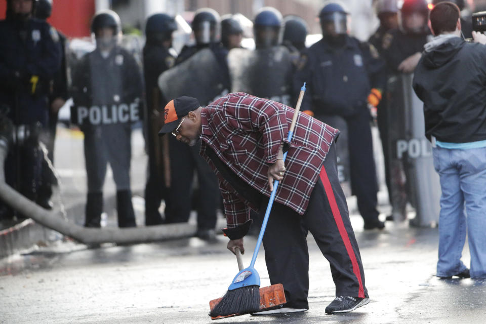 A man cleans up during a protest, Monday, April 27, 2015, following the funeral of Freddie Gray in Baltimore. (AP Photo/Matt Rourke)