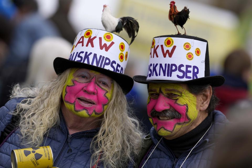 Costumed people attend a rally in Munich, Germany, Saturday, April 15, 2023 marking the nuclear shutdown in Germany. Germany is shutting down the last three nuclear power plants today as a part of an energy transition agreed by successive governments. Slogan reads 'Nuclear Power Plant Shutdowner.' (AP Photo/Matthias Schrader)