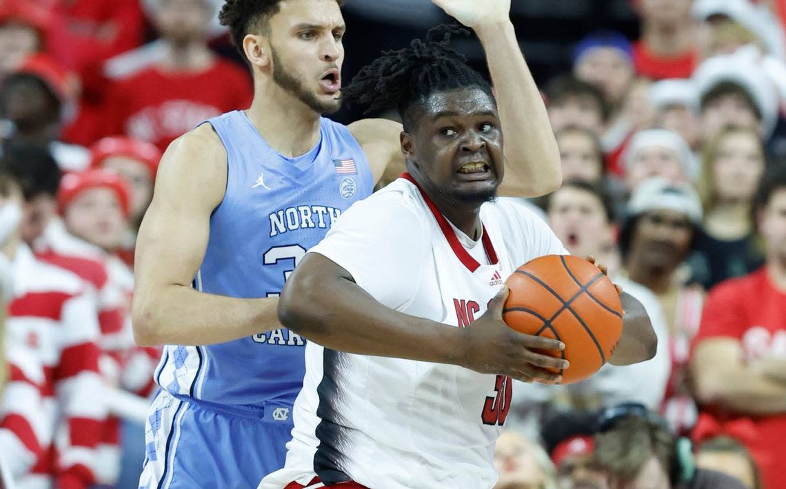N.C. State’s D.J. Burns Jr. (30) works his way around North Carolina’s Pete Nance (32) during the first half of N.C. State’s game against UNC at PNC Arena in Raleigh, N.C., Sunday, Feb. 19, 2023.