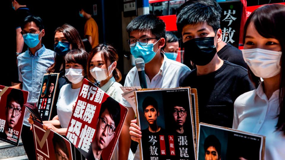 Joshua Wong (center) and other prominent pro-democracy activists campaign during an unofficial primary election in Hong Kong on July 12, 2020. - ISAAC LAWRENCE/AFP/AFP via Getty Images