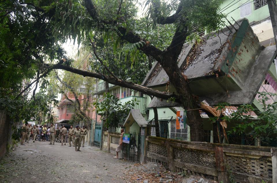 Indian police and bystanders look at a collapsed house in Siliguri on April 25, 2015. (DIPTENDU DUTTA/AFP/Getty Images)