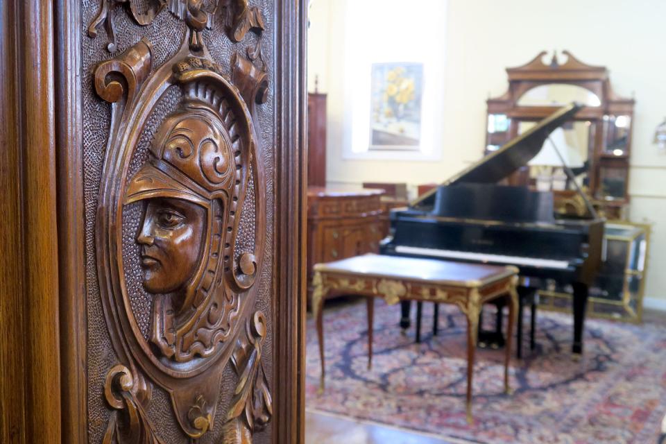 A carving on a cabinet door in the first floor gallery at Mill House Antiques in Long Branch Monday, February 27, 2023.  The second-generation, Long Branch-based provider of antique furnishings, lighting, jewelry, grand pianos, and rare small valuables has been in operation since 1973.