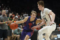 Miami forward Sam Waardenburg (21) defends Clemson forward Hunter Tyson (5) during the second half of an NCAA college basketball game, Saturday, Dec. 4, 2021, in Coral Gables, Fla. (AP Photo/Marta Lavandier)