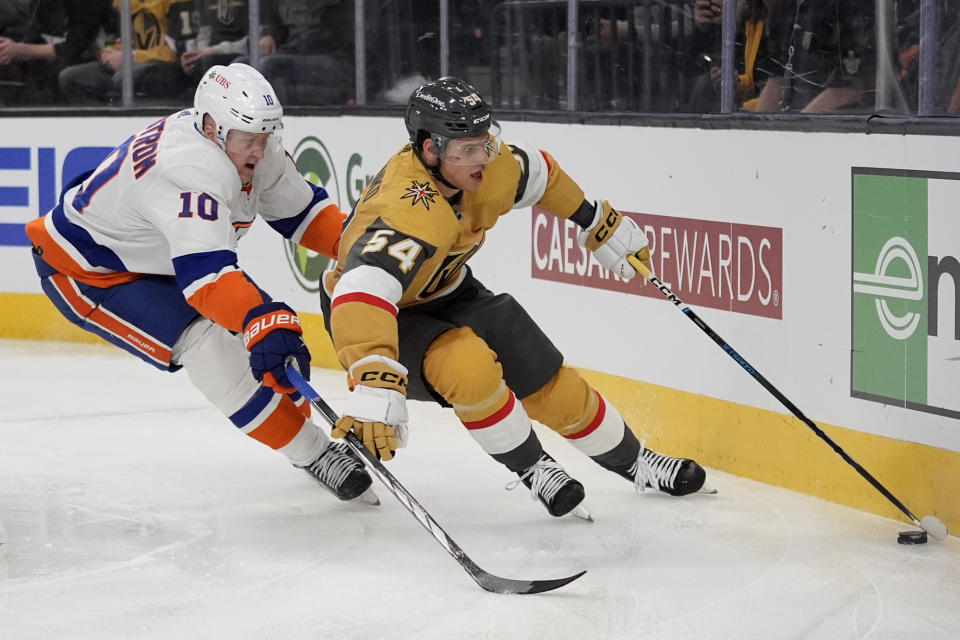 Vegas Golden Knights' Grigori Denisenko skates around New York Islanders right wing Simon Holmstrom (10) during the second period of an NHL hockey game Saturday, Jan. 6, 2024, in Las Vegas. (AP Photo/John Locher)