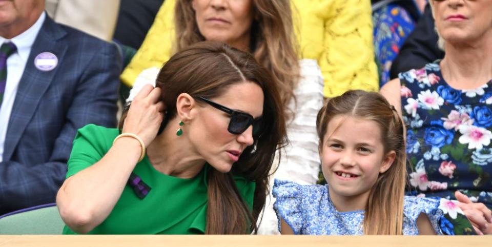 princess of wales and princess charlotte of wales watch carlos alcaraz vs novak djokovic in the wimbledon 2023, kate middleton wearing a green dress and charlotte a blue gloral dress, sat in the royal box side by side