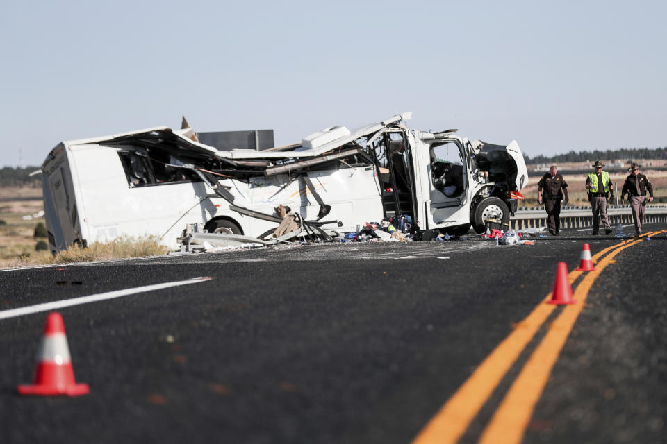 Authorities work the scene where at least four people were killed in a tour bus crash near Bryce Canyon National Park, Friday, Sept. 20, 2019, in Utah. (Spenser Heaps/The Deseret News via AP)