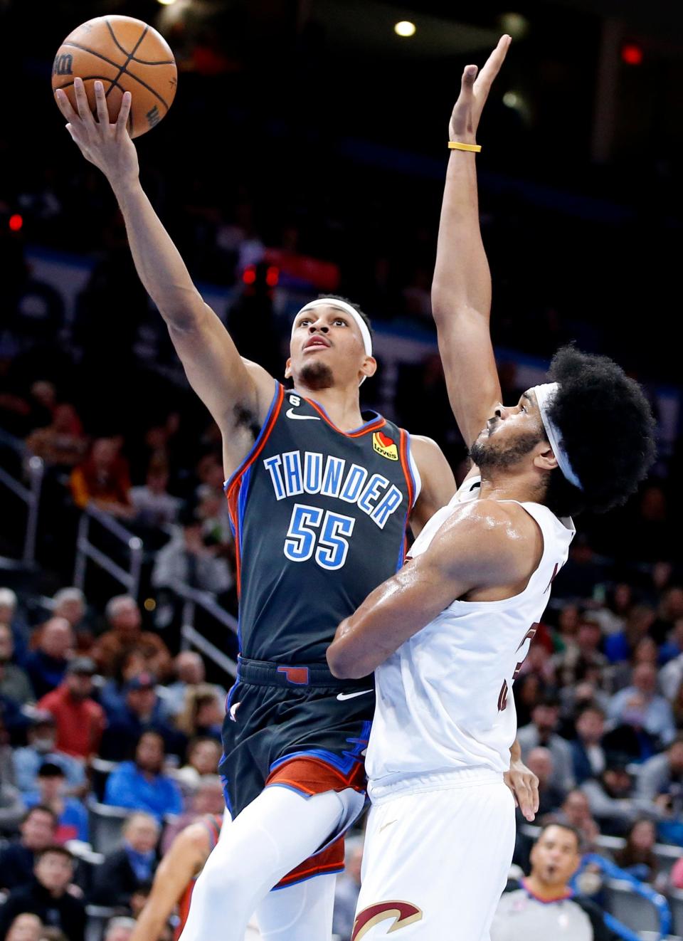 Oklahoma City's Darius Bazley (55)vgoes to the basket as Cleveland's Jarrett Allen (31) defends in the first half during the NBA basketball between the Oklahoma City Thunder and the Cleveland Cavaliers at the Paycom Center in Oklahoma City, Friday, Jan.27, 2023. 