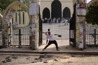 A group of protestors pelt stones on another after Friday prayers at Baitul Mokarram mosque in Dhaka, Bangladesh, Friday, March 26, 2021. Witnesses said violent clashes broke out after one faction of protesters began waving their shoes as a sign of disrespect to Indian Prime Minister Narendra Modi, and another group tried to stop them. Local media said the protesters who tried to stop the shoe-waving are aligned with the ruling Awami League party. The party criticized the other protest faction for attempting to create chaos in the country during Modi’s visit. (AP Photo/Mahmud Hossain Opu)