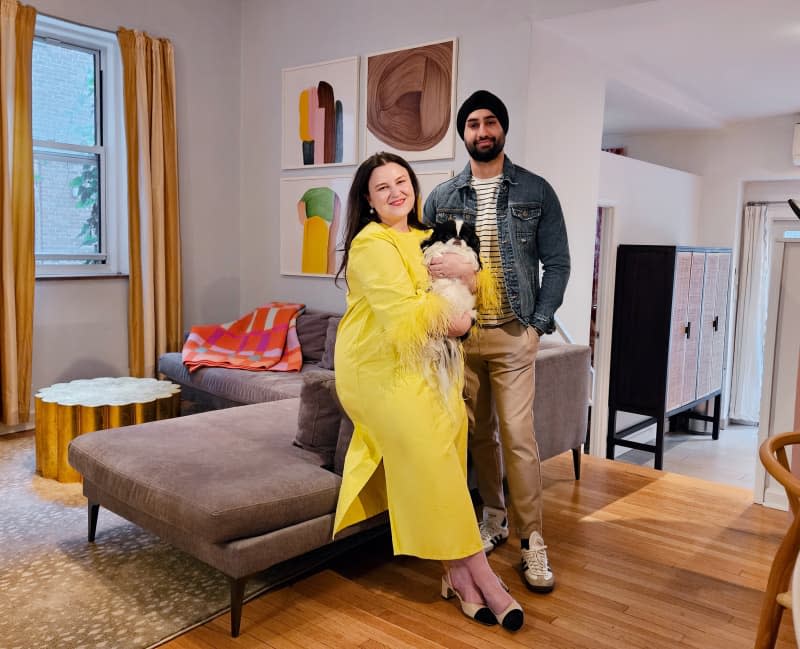 couple with dog in their living room