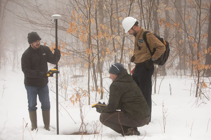 Timothy De Smet, Alex Nikulim and Nathan Graber use a global navigation satellite system and geodetic antenna to locate an abandoned oil well in Olean, New York