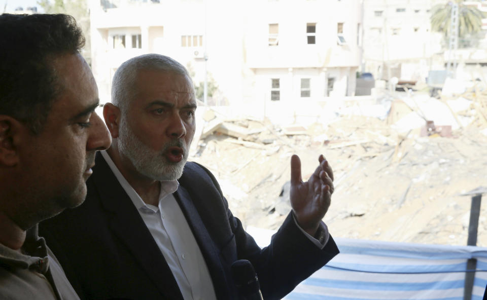 Hamas' supreme leader Ismail Haniyeh talks to journalists during a tour of a destroyed building, in Gaza City, Wednesday, March 27, 2019. Haniyeh made his first public appearance since a new round of cross-border violence with Israel this week. On Wednesday he visited the rubble of his Gaza City office, which was destroyed in an Israeli airstrike. (AP Photo/Adel Hana)