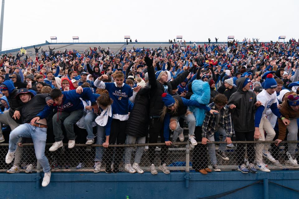 Kansas fans celebrate and begin to storm the field after the Jayhawks topped Oklahoma for a 38-33 win this past weekend inside David Booth Kansas Memorial Stadium.