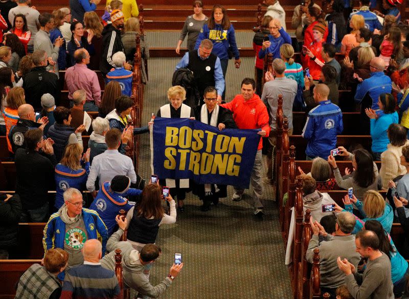 Boston Marathon bombing witness Carlos Arredondo blesses the runners during a service at Old South Church in Boston