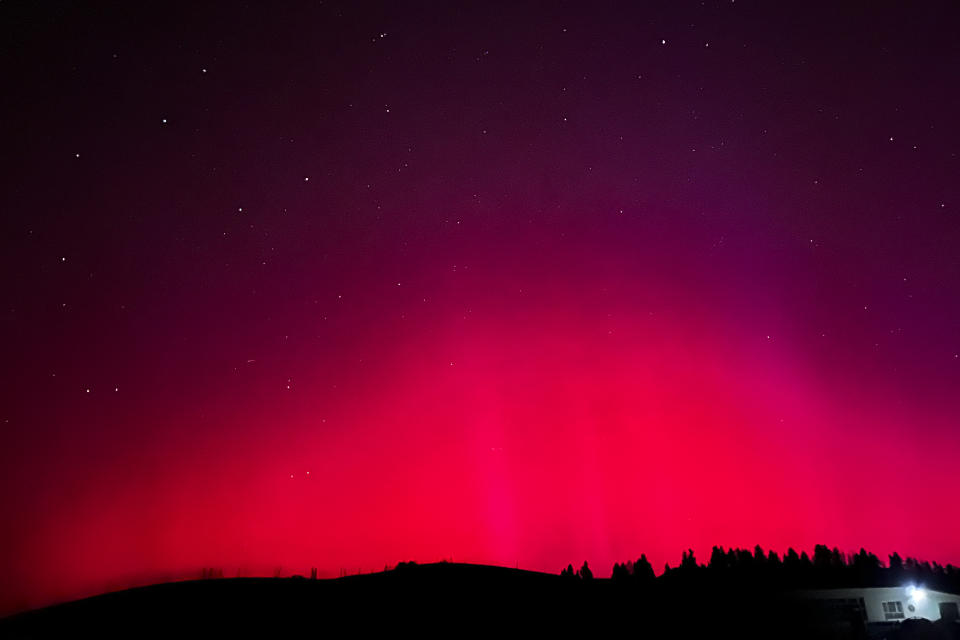 In this photo released by Xinhua News Agency, the Northern Lights, or Aurora Borealis, are seen near Nanshan scenic spot in Urumqi in northwestern China's Xinjiang Uyghur Autonomous Region, Saturday, May 11, 2024. An unusually strong solar storm hitting Earth produced stunning displays of color in the skies across the Northern Hemisphere early Saturday, with no immediate reports of disruptions to power and communications. (Chen Shuo/Xinhua via AP)