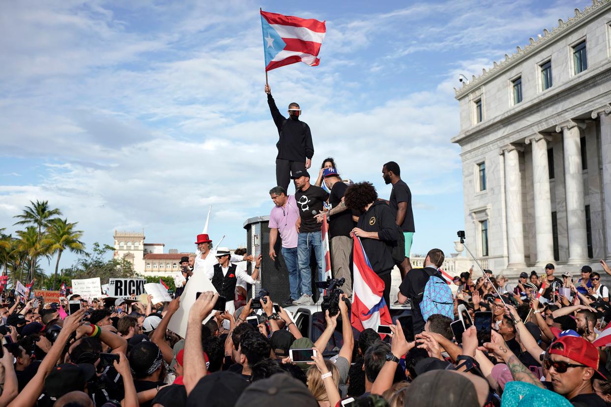 Puerto Rican singer Ricky Martin (C), Puerto Rican rapper Rene Perez, aka Residente, (R) Puerto Rican reggaeton singer Bad Bunny (top), take part of a demonstration demanding Governor Ricardo Rossello's resignation in San Juan, Puerto Rico on July 17, 2019.  (Photo: Eric Rojas/AFP/Getty Images)