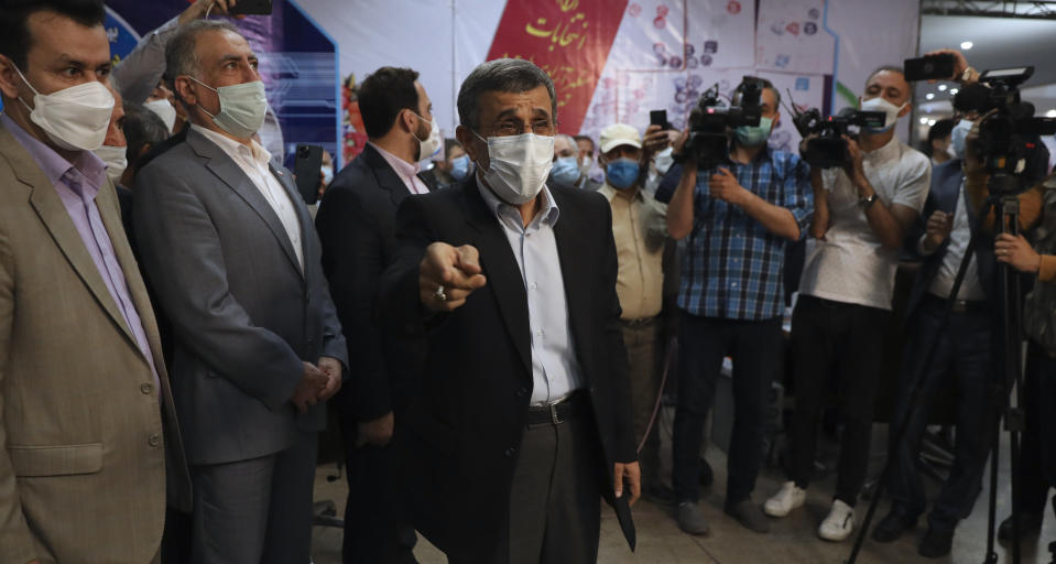 Former Iranian President Mahmoud Ahmadinejad, center, speaks with journalists while registering his name as a candidate for the June 18 presidential elections at the elections headquarters of the Interior Ministry in Tehran, Iran, Wednesday, May 12, 2021. The country's former firebrand president will run again for office in upcoming elections in June. The Holocaust-denying Ahmadinejad has previously been banned from running for the presidency by Supreme Leader Ayatollah Ali Khamenei in 2017, although then, he registered anyway. (AP Photo/Vahid Salemi)