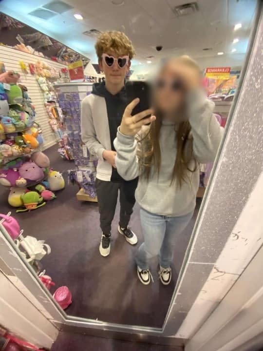 Bobby Maher and his girlfriend take a photo in a mirror