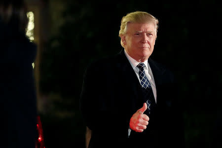 U.S. President-elect Donald Trump gives a thumbs up to the media as he arrives at a costume party at the home of hedge fund billionaire and campaign donor Robert Mercer in Head of the Harbor, New York, U.S., December 3, 2016. REUTERS/Mark Kauzlarich