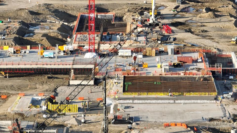 The massive Intel semiconductor plant construction continues April 20 in New Albany. So far, Intel has committed 1.6 million work hours to the project, poured 32,000 cubic yards of concrete and installed 4,300 tons of rebar, 15,000 linear feet of underground pipe and 210,000 linear feet of underground conduit, enough for 700 football fields.