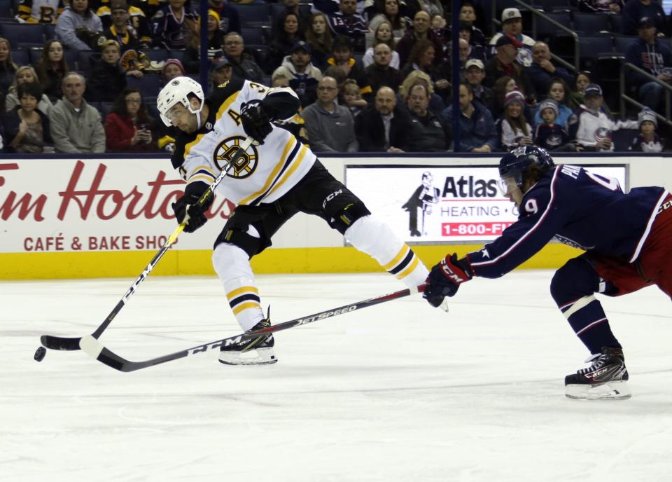 <p>
              Boston Bruins forward Patrice Bergeron, left, shoots the puck against Columbus Blue Jackets forward Artemi Panarin, of Russia, during the first period of an NHL hockey game in Columbus, Ohio, Tuesday, March 12, 2019. Bergeron scored on the play. (AP Photo/Paul Vernon)
            </p>