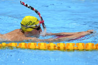 FILE - In this July 21, 2021, file photo, Mackenzie Horton of Australia exercises during a swimming training session at the Tokyo Aquatics Centre at the 2020 Summer Olympics in Tokyo, Japan. With hundreds of swimmers scrambling to get their warmup done at the same time, multiple athletes in each lane, everyone diving over one another and some competitors using snorkels, kickboards and other paraphernalia, warmup is organized chaos. (AP Photo/Matthias Schrader, File)