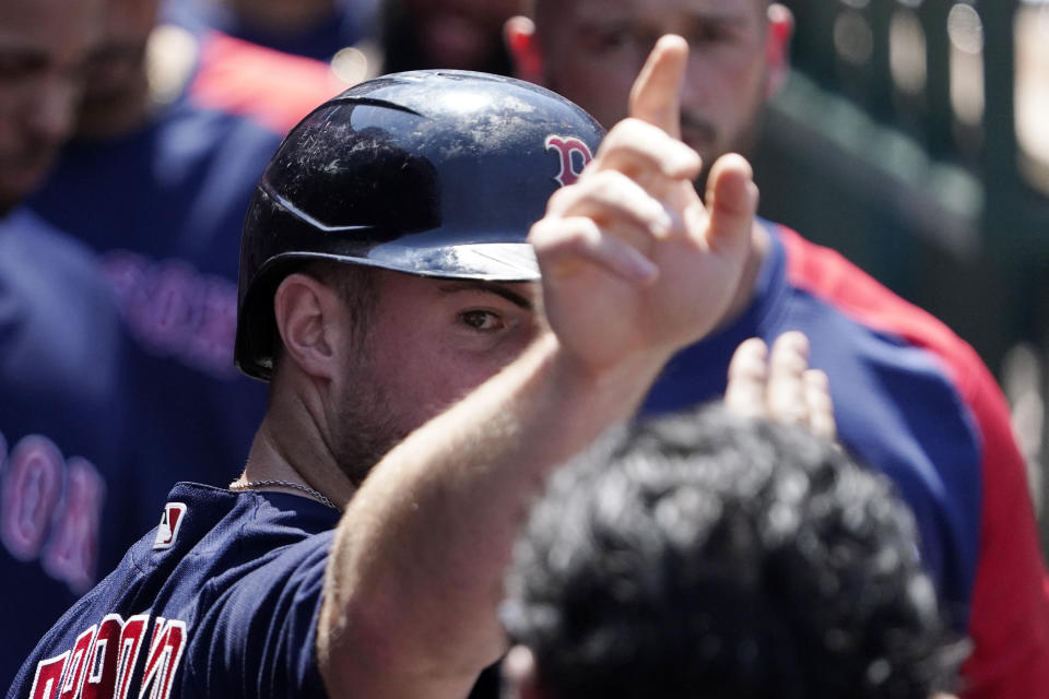 Boston Red Sox's Christian Arroyo is congratulated by teammates in the dugout after scoring on a single by Bobby Dalbec during the fifth inning of a baseball game against the Los Angeles Angels Wednesday, July 7, 2021, in Anaheim, Calif. (AP Photo/Mark J. Terrill)