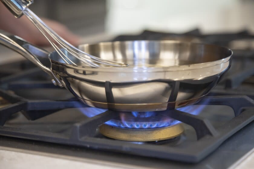 EL SEGUNDO, CA - JUNE 02: The LA City Council unanimously voted to ban gas stoves in new Los Angeles buildings and require only electric stoves and ovens. Cooking columnist Ben Mims tests the difference between the gas burner and electric induction stovetop in the Times kitchen. Photographed on Thursday, June 2, 2022 at LA Times Test Kitchen in El Segundo, CA. (Myung J. Chun / Los Angeles Times)