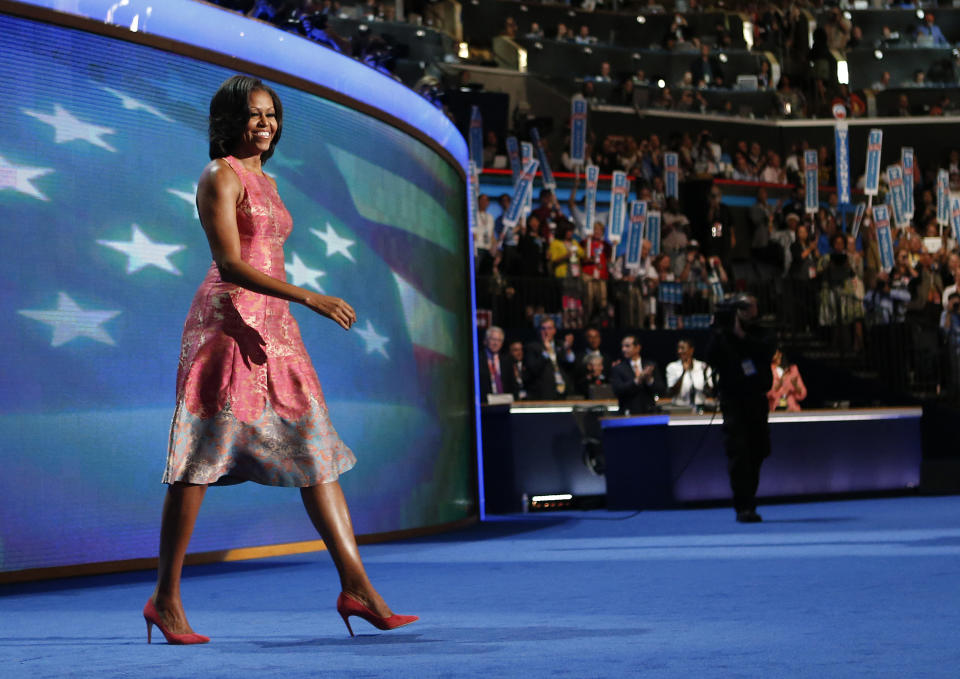 FILE - In this Tuesday, Sept. 4, 2012 file photo, first lady Michelle Obama walks onto the stage at the Democratic National Convention in Charlotte, N.C. Tracy Reese, who designed Obama's hot pink silk jaquard dress with pale blue trim at the hem, says she's rushing to make more of them. She told NBC's "Today" show that the dress will cost under $500. (AP Photo/Jae C. Hong, File)