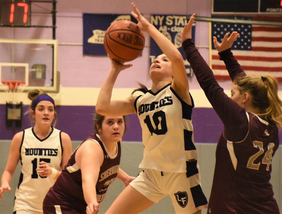 Little Falls Mountie Adriana Izzo (10) goes up with a shot between defenders against Sherburne-Earlville Monday.