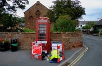 FILE PHOTO: A BT telephone engineer carries out work outside a traditional British Telecom red telephone box in Parkgate