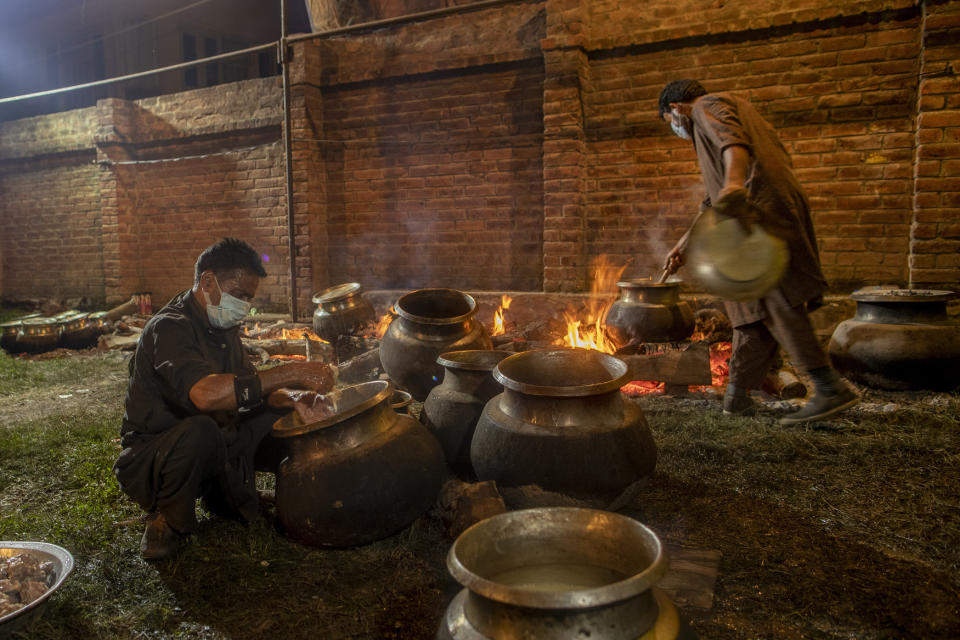 Kashmiri Wazas, or chefs, cook for a wedding feast Wazwan, on the outskirts of Srinagar, Indian controlled Kashmir, Tuesday, Sept. 16, 2020. The coronavirus pandemic has changed the way people celebrate weddings in Kashmir. The traditional week-long feasting , elaborate rituals and huge gatherings have given way to muted ceremonies with a limited number of close relatives attending. With restrictions in place and many weddings cancelled, the traditional wedding chefs have little or no work. The virus has drastically impacted the life and businesses in the region. (AP Photo/ Dar Yasin)