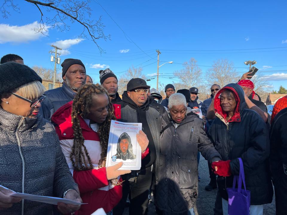 Kimberly Woodson (with flyer), Teferi Brent (center left), Maureen Taylor (center right) and dozens of other Detroiters gathered on March 29, 2023 to canvass a northwest side neighborhood where an 80-year-old woman was sexually assaulted outside of her home on Memorial Street just days prior. The suspect was still at large. Together, they passed out hundreds of flyers that included a sketch of suspect.