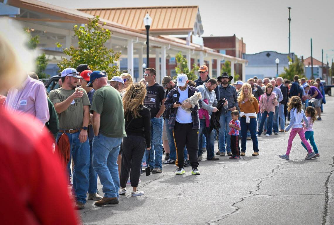 People lined up to have a photo taken with Sen. Ted Cruz and Amanda Adkins, the Republican candidate in Kansas’ 3rd Congressional District, during a stop Friday, Oct. 14, 2022, in Ottawa, Kansas.