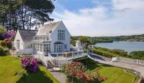 <p>This white-washed Cornish gem is beautiful in every way possible. With idyllic views of the glistening water, two acres of land, mature gardens, an additional guest cottage and a boathouse, it really is as dreamy as can be. When can we move in?</p><p><a class="link " href="https://www.rightmove.co.uk/property-for-sale/property-81125296.html" rel="nofollow noopener" target="_blank" data-ylk="slk:TOUR NOW;elm:context_link;itc:0;sec:content-canvas">TOUR NOW</a></p>