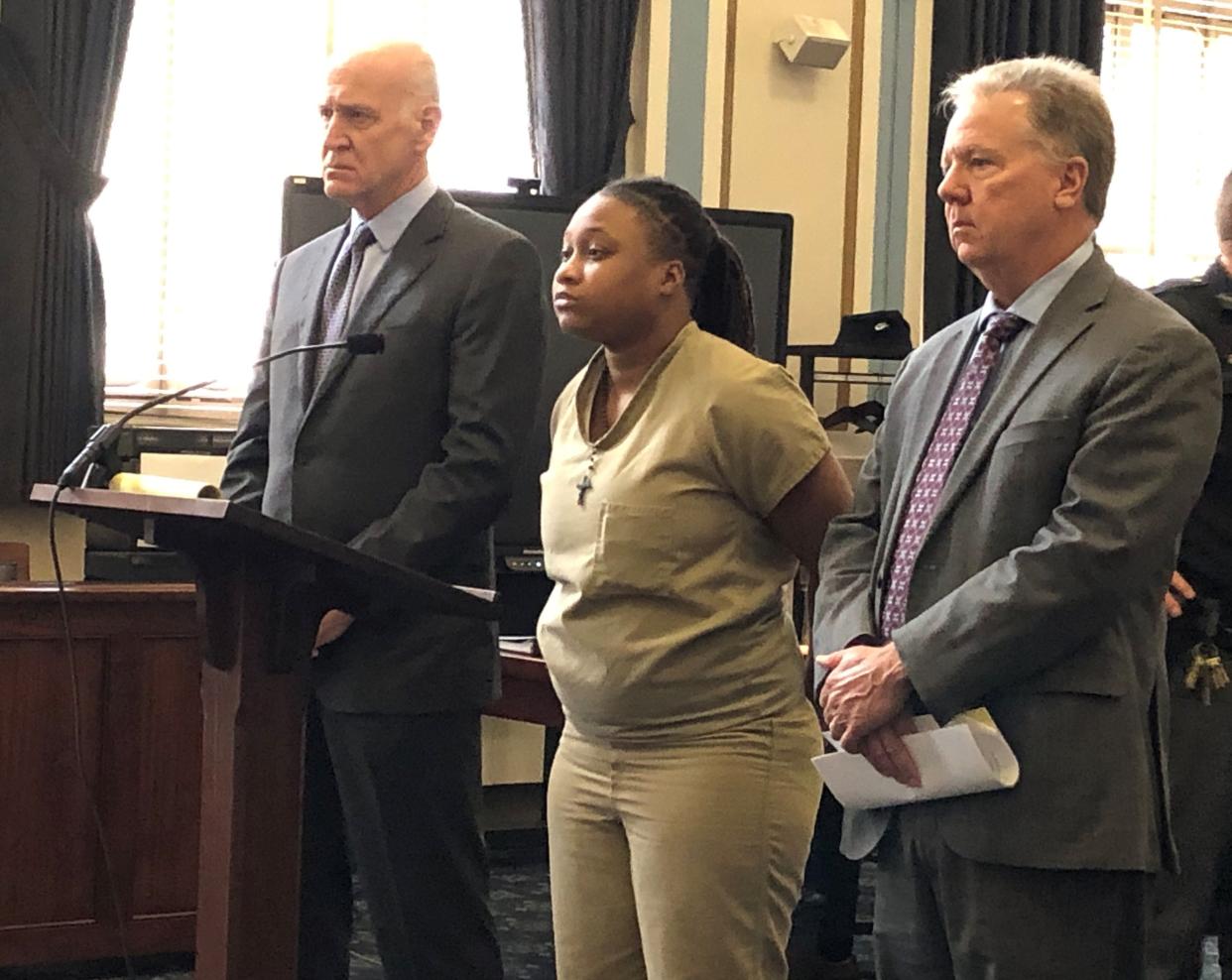 Jamiah Richardson stands between her attorneys, Stephen Wenke, at left, and Jeffrey Adams, before her plea hearing Thursday in Hamilton County Common Pleas Court.