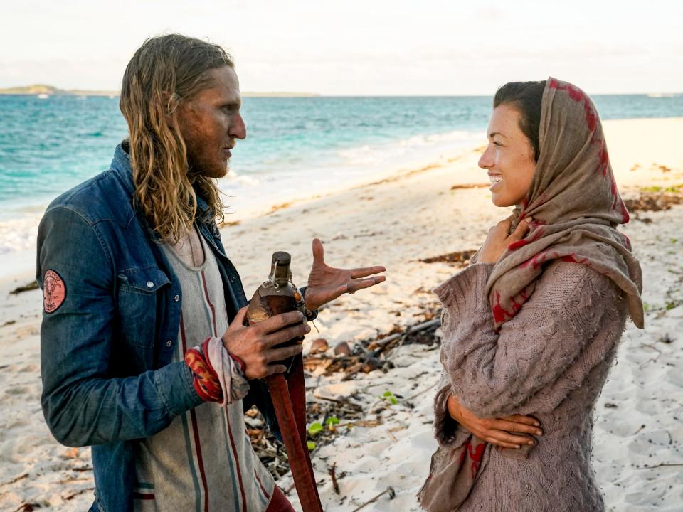 Tyson Apostol holding a water bottle and talking to Parvati Shallow on survivor