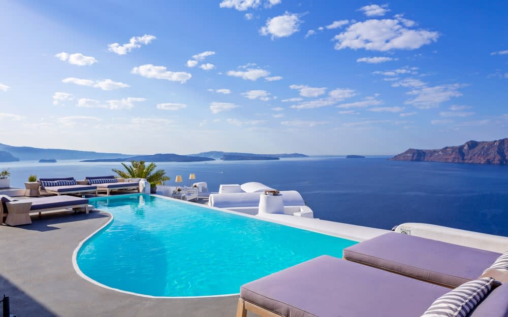 Infinity pools which blend into the sky, a candle-lit rooftop restaurant and tranquil white-washed cottages set into a cliff overlooking the volcanic Caldera and Aegean Sea makes Katikies Santorini a dreamy escape for a mini-moon - Â© christos drazos photography