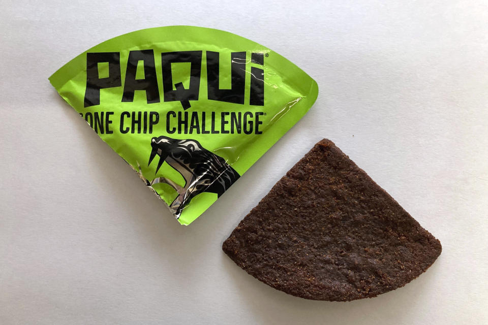 FILE - A Paqui One Chip Challenge chip is displayed in Boston, Friday, Sept. 8, 2023. A lawsuit was filed against a Thursday, July 11, 2024 in the case of a Massachusetts teen who died after he participated in a spicy tortilla chip challenge on social media. (AP Photo/Steve LeBlanc, File)