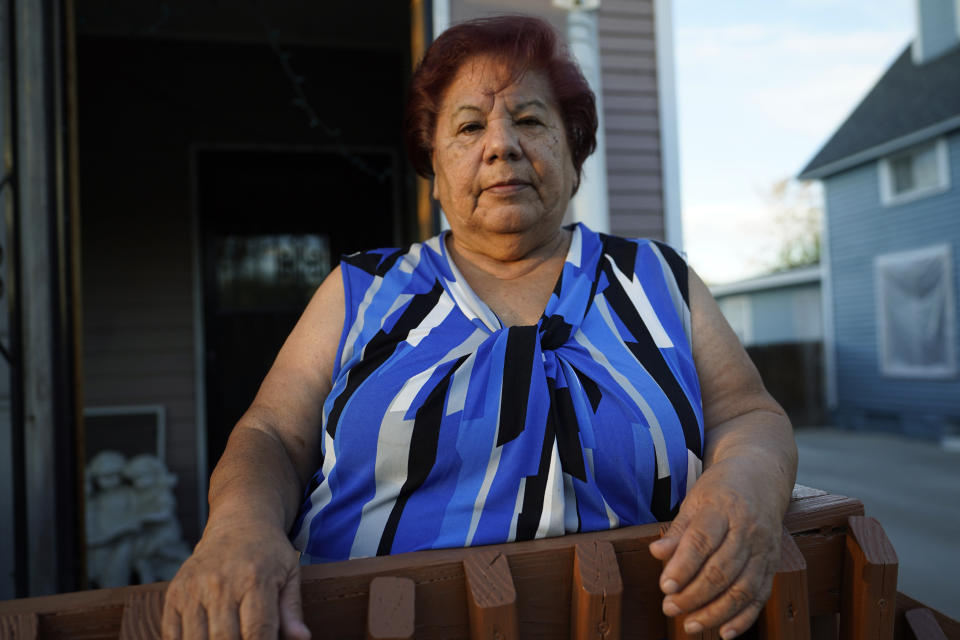 Carolina Sanchez stands outside the home that she shared with her husband, Saul, before an interview Monday, Oct. 12, 2020, in Greeley, Colo. (AP Photo/David Zalubowski)