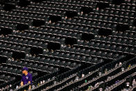 An usher sits among the empty seats during the eighth inning after a rain delay prompted most fans to leave the ballpark during a game between the San Diego Padres and Colorado Rockies at Coors Field on July 7, 2014 in Denver, Colorado. The Padres defeated the Rockies 6-1. (Photo by Justin Edmonds/Getty Images)