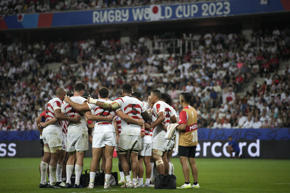 The Japan team form a huddle during the Rugby World Cup Pool D match between England and Japan in the Stade de Nice, in Nice, France Sunday, Sept. 17, 2023. (AP Photo/Daniel Cole)