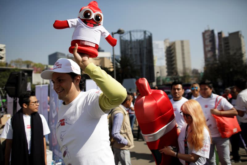 A member of an organization holds a condom puppet during an event organized by AIDS Healthcare Foundation for the International Condom Day, in Mexico City