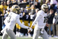 Purdue quarterback Aidan O'Connell (16) celebrates with teammate wide receiver David Bell (3) after scoring on a 6-yard touchdown run during the first half of an NCAA college football game against Iowa, Saturday, Oct. 16, 2021, in Iowa City, Iowa. (AP Photo/Charlie Neibergall)