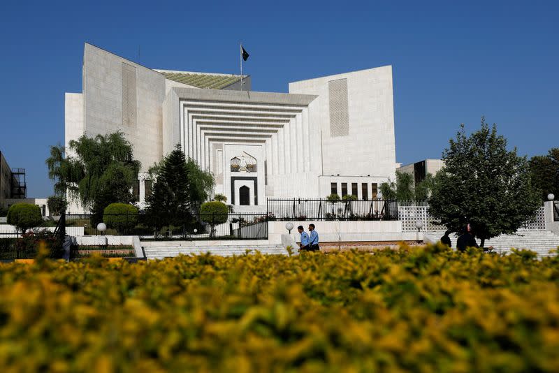 FILE PHOTO: Police officers walk past the Supreme Court of Pakistan building, in Islamabad